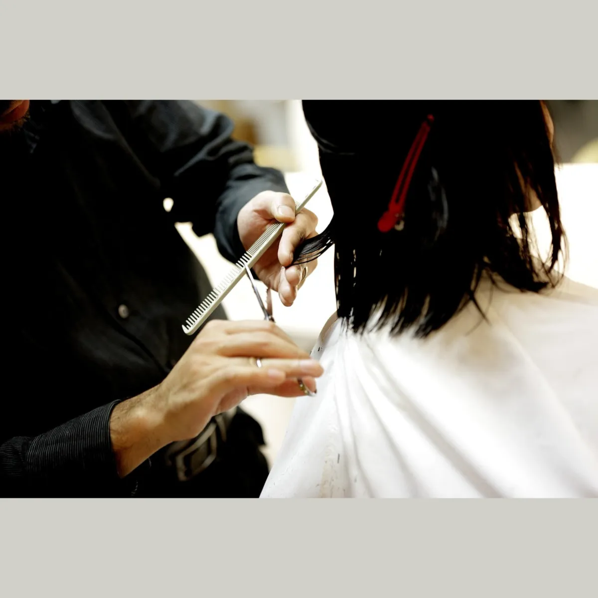 Haircut in progress on dark shoulder-length hair