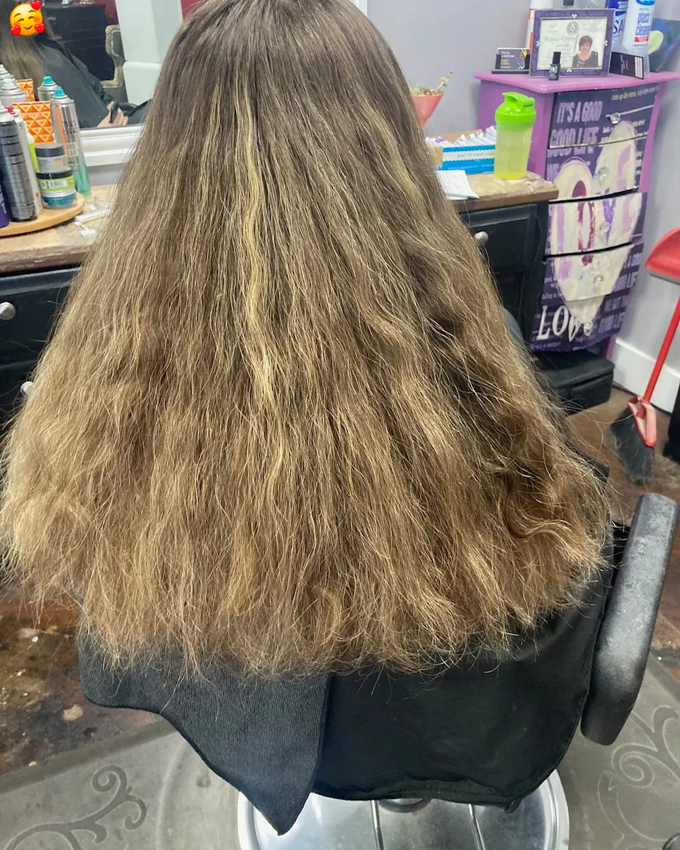 Long naturally wavy hair showing existing texture before a salon service